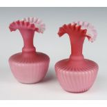 A pair of Victorian pink glass vases with wavy rims 16cm
