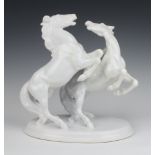 An Austrian porcelain group of 2 rearing white horses 32cm