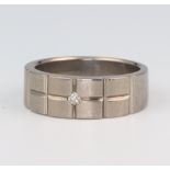 A gentleman's titanium wedding band set with a brilliant cut diamond, approx. 0.05ct, size P, 4