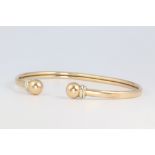 A 9ct yellow gold torque bangle 7.8 grams