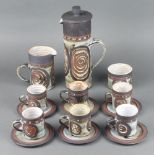 A Studio Pottery coffee set comprising coffee pot, milk jug, sugar bowl, 6 coffee cans and 6