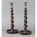 A pair of 1930's spiral turned oak candlesticks with metal sconces 37cm h x 14cm Light contact marks