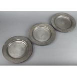 Three 18th/19th Century circular pewter plates, the reverse with touchmark 23cm diam