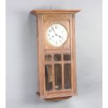 A 1920's 8 day striking wall clock with 15cm dial contained in an oak case 70cm h x 37cm w x 19cm