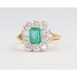 A yellow metal 18ct emerald and diamond ring the centre stone 1.1ct, the 10 brilliant cut diamonds