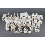 A collection of crested china including a Norwich Warbler, a Tenby oast house, a Matlock Bath