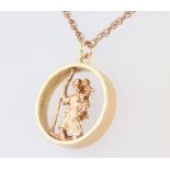 A 9ct yellow gold St Christopher pierced pendant on a 64cm chain, 18 grams