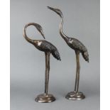 A pair of 20th Century Japanese bronze figures of storks raised on circular bases 52cm h x 12cm