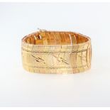 A yellow metal 3 colour stamped 18k bracelet, 60 grams, 3cm wide, 19cm long