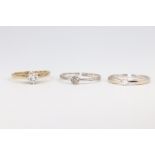 Three 9ct yellow gold diamond set rings, size N, 5 grams