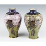 A pair of Royal Doulton oviform vases decorated with stylised flowers 24cm