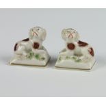 A pair of 19th Century Sampson figures of spaniels on cushions 4.5cm