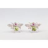 A pair of white metal 18ct bug ear studs set with oval peridot 1.7ct, cabochon ruby 0.17ct and