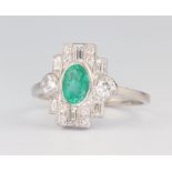 A white metal stamped Plat Edwardian style oval emerald and diamond ring, the centre stone 0.8ct,