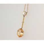 A yellow metal oval citrine and pearl pendant 4cm on a 45cm 9ct yellow gold chain, gross weight 4