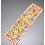 A white, green and purple ground Chobi Kilim runner with 4 geometric design and 4 diamonds to the