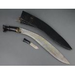 A Kukri with wooden grip, 1 skinning knife and leather scabbard Large section of timber missing to