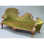 A Victorian rosewood show frame sofa, heavily carved throughout, the seat of serpentine outline
