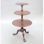 A 19th Century circular revolving 3 tier dumb waiter, raised on pillar and tripod base with brass