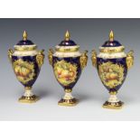 A set of 3 20th Century Coalport blue ground twin handled urns and covers with panels decorated