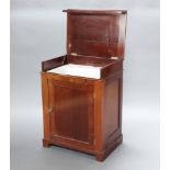 A 19th Century mahogany enclosed washstand, the hinged lid revealing a hand basin above a cupboard