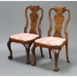 A pair of Queen Anne style figured walnut slat back chairs with shaped drop in seats, raised on