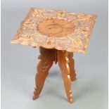 A 1930's square Eastern carved hardwood occasional table raised on a folding stand 39cm h x 35cm w x