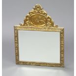 A Dutch rectangular bevelled plate mirror contained in an embossed frame, the arched top decorated a