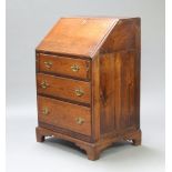 An 18th/19th Century oak bureau the fall front revealing a well fitted interior above 3 long drawers