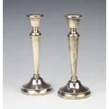 A pair of tapered silver candlesticks with beaded decoration Birmingham 1962, 20cm These sticks