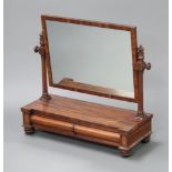 A Victorian rectangular plate dressing table mirror contained in a mahogany swing frame, base fitted