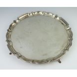 A silver salver with pie crust rim on pad feet, Chester 1913, 30cm, 840 grams
