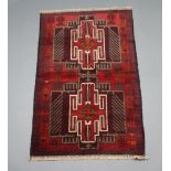 A red, blue and white ground Belouche rug with 2 medallions to the centre 133cm x 84cm