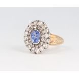A white and yellow metal stamped 15 oval sapphire and diamond cluster ring, the centre stone 1.5ct