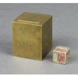 An Eastern metal dice contained within a polished bronze cube 5cm x 4cm x 4cm The bronze cube is