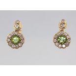 A pair of yellow metal 18ct peridot and diamond cluster earrings, the 2 centre stones approx. 1.0ct,