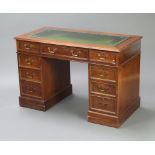 A mahogany pedestal desk with green writing surface fitted 1 long and 8 short drawers with brass