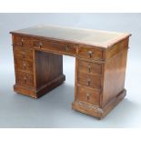 An Edwardian oak desk with green inset writing surface above 1 long and 8 short drawers 84cm h x
