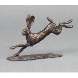 In the manner of Richard Cooper & Co., an unmarked bronze figure of a running hare 7cm x 15cm x 8cm