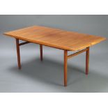 A mid-Century teak dining table with chamfered edge, raised on turned supports 73cm h x 90cm w x
