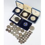 A Victorian crown 1887 in a silver mount as a brooch, 3 silver commemorative proof crowns and