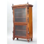 A 19th Century Continental mahogany display cabinet enclosed by bevelled plate panelled doors having