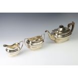 A silver 3 piece tea set of rounded rectangular form London 1912, gross weight 1140 grams
