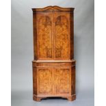 A Queen Anne style figured walnut double corner cocktail cabinet with shaped cornice, the upper