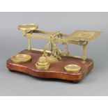 A pair of 19th Century brass letter scales, raised on an oak base together with 6 brass weights, 1
