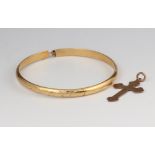 A 9ct yellow gold bangle and a ditto cross pendant, 4 grams