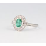 A white metal stamped Plat. Art Deco style emerald and diamond ring, the centre stone 0.95ct, the