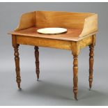 A Victorian bleached mahogany wash stand with raised 3/4 gallery, bowl receptacle and associated
