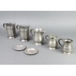 Two Victorian pewter pint tankards the bases indistinctly engraved Naylor, a pewter spouted jug