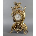 A battery operated mantel timepiece with paper dial and Arabic numerals contained in a gilt metal